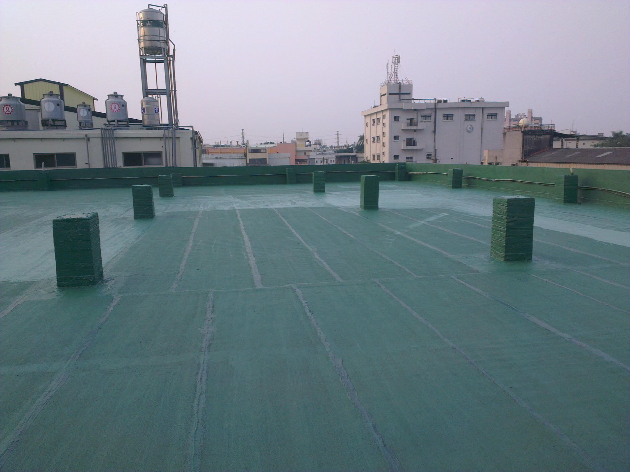 Seamless spray-applied polyurea waterproofing membrane across a roof deck