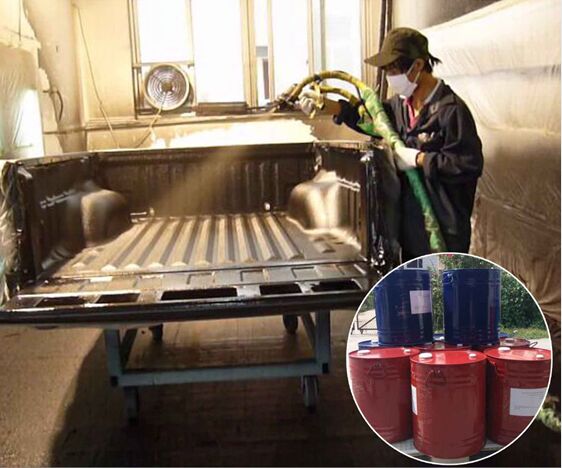 Operator spray-applying a polyurea bed liner inside a pickup truck bed