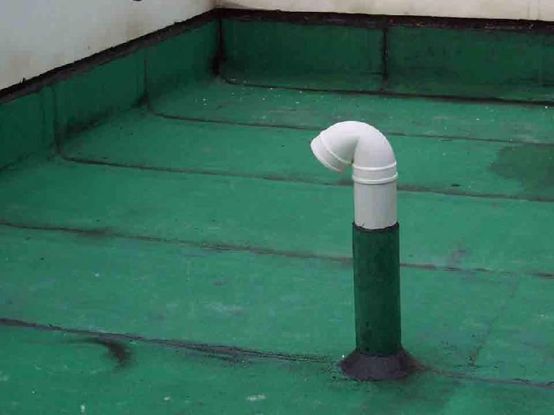 Polyurea waterproofing membrane sealing a rooftop pipe penetration